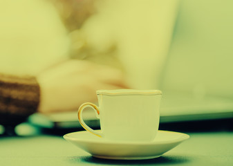 Man works in bussiness office with computer or laptop or notebook and papper graf and he drinks coffee