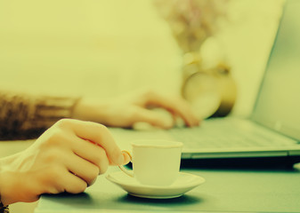 Man works in bussiness office with computer or laptop or notebook and papper graf and he drinks coffee