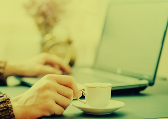 Man works in bussiness office with computer or laptop or notebook and papper graf and he drinks coffee