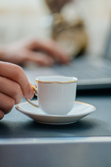 Man works in bussiness office with computer or laptop or notebook and papper graf and he drinks coffee
