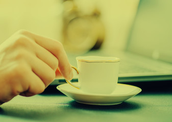 Man works in bussiness office with computer or laptop or notebook and papper graf and he drinks coffee