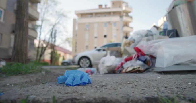 Surgical hand gloves thrown on ground by thrash in city street covid 19 pandemic crisis ecology