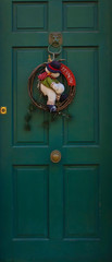 Traditional door decorated with a Christmas wreath