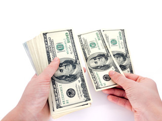 American dollars and hand isolated on a white background. To count money. Banknotes and hands. Business and finance.