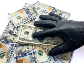 American dollars and hand. To steal money. Composition of paper money and hands. Thief. Rob....