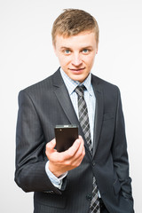 The man is using a smartphone. Modern mobile phone in hand.