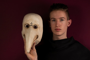 Young boy with plague doctor mask