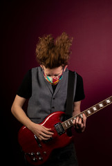 Obraz premium Coronavirus, quarantine at home, playing guitar in protection mask