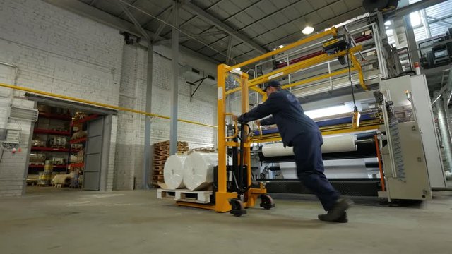 worker operating forklift in warehouse