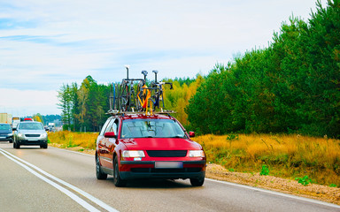 Fototapeta na wymiar Car with bicycles at highway road in Poland concept reflex