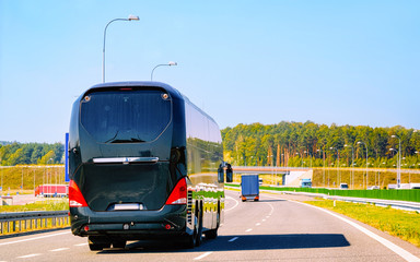 Black Tourist bus on road in Poland reflex