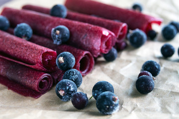 Handmade fruit pastilles with black currants on craft paper. Natural and healthy snacks. Sugar-free, healthy, sweet. Organic food. Close-up