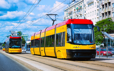 Fototapeta na wymiar Trolleys on road in Warsaw city center reflex