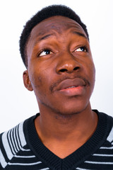 Obraz premium Young handsome African man against white background