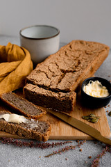 brown buckwheat bread on wooden board with butter and milk 