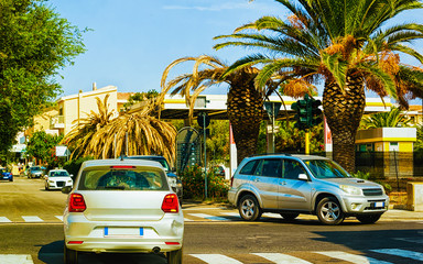 Cars on road in Santa Teresa Gallura Sardinia reflex