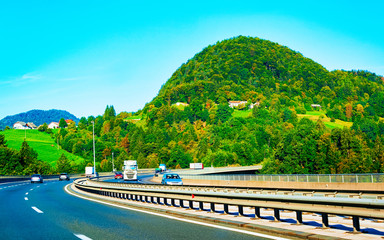 Scenic landscape and cars in road in Slovenia Julian Alps reflex