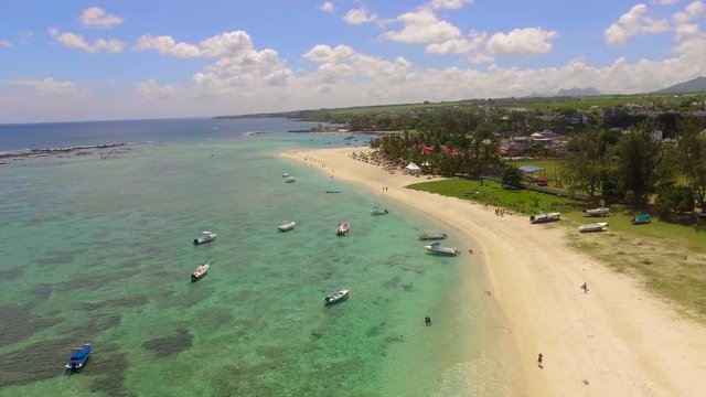 Aerial panoramic view over Flic en Flac on the island of Mauritius with flight over the beautiful tropical beach