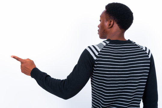 Young handsome African man against white background
