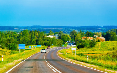 Fototapeta na wymiar Scenery with car on road in Poland reflex