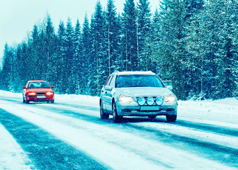 Car in winter road in Rovaniemi of Lapland reflex