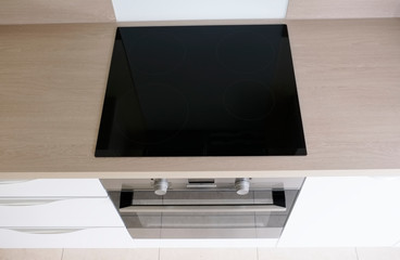 Top view of induction cooker hob on kitchen worktop