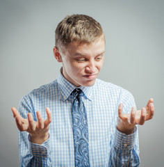 young man looking shocked and surprised in full disbelief hands up in air