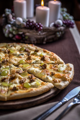 Pizza with various cheese, walnuts and grapes