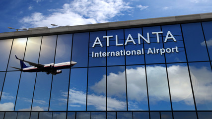 Airplane landing at Atlanta mirrored in terminal - obrazy, fototapety, plakaty