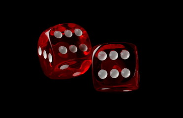 Red playing, gambling die, dice for tabletop games and poker isolated on black background with clipping path