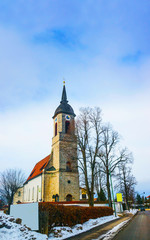 Fototapeta na wymiar Road View to a church in Germany in winter reflex
