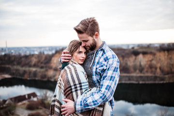 Young couple kissing at sunset. Man and woman. Man in shirt . Camping.