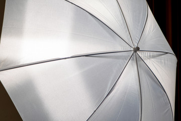 White color photography umbrella close-up. Diffuser umbrella.
