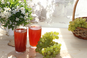 Citrus grape cider, juice and ingredients on a sunny table. The concept of detox diet and weight...