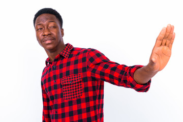Naklejka premium Young handsome African man against white background