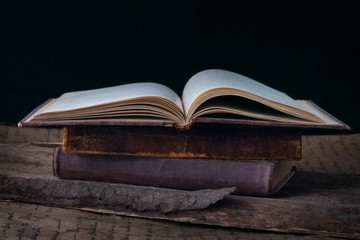 old book open on a wooden table