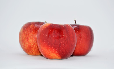 
red, ripe apples on a white background. apples are a source of vitamins and iron during quarantine and self-isolation