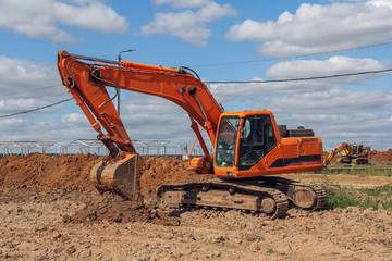 Fototapeta na wymiar Crawler excavator at a construction site. Special machinery for earthworks. Powerful unit