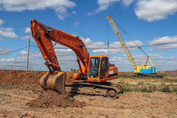 Fototapeta na wymiar Crawler excavator at a construction site. Special machinery for earthworks. Powerful unit
