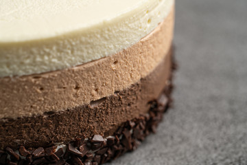 Cake with souffle milk chocolate cream on gray background. side view, close up, selective focus.