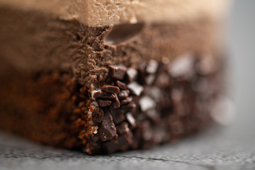 Cake with souffle milk chocolate cream on gray background. side view, close up, selective focus.