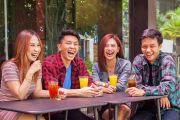 Cheerful teenagers laughing together in restaurant