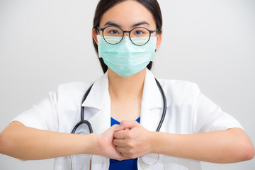 Portrait beautiful Asian woman doctor with stethoscope and mask to protect Corona Virus clasp hand gesture of beg for help cooperation, work together confederate to stop the epidemic COVID 19 concept