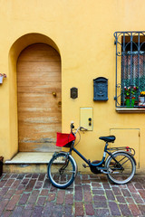 Fototapeta na wymiar Bicycle parked next to door of old house