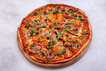 Pizza with boiled pork and dried tomatoes. Tomato sauce, sour cream, sliced boiled pork, mushrooms and cheese. European cuisine. The work of a professional chef. Dish from a restaurant or cafe menu