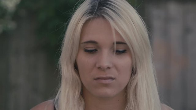 A woman who is stressed and anxious stares forward in a portrait shot. Filmed on RED camera in 4k. Free preview.