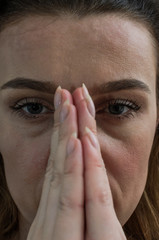 Portrait of a young woman who is praying