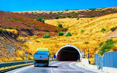 Truck on road with underpass in Cagliari Sardinia reflex