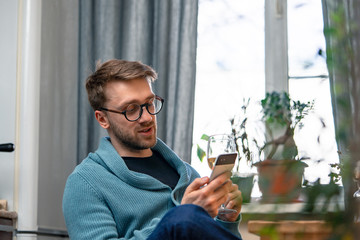 Man Calling His Friends And Drinking Wine With Them By Video Chat. Online Meeting. Stay Home. Social Distance, Isolation