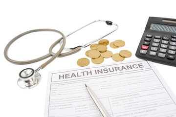Health insurance form with coins and stethoscope